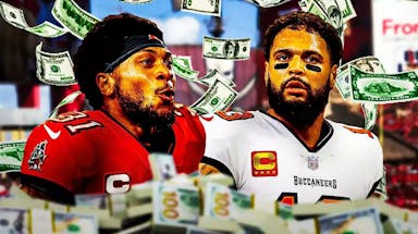 Buccaneers DB Antoine Winfield Jr. and WR Mike Evans with money falling all around.
