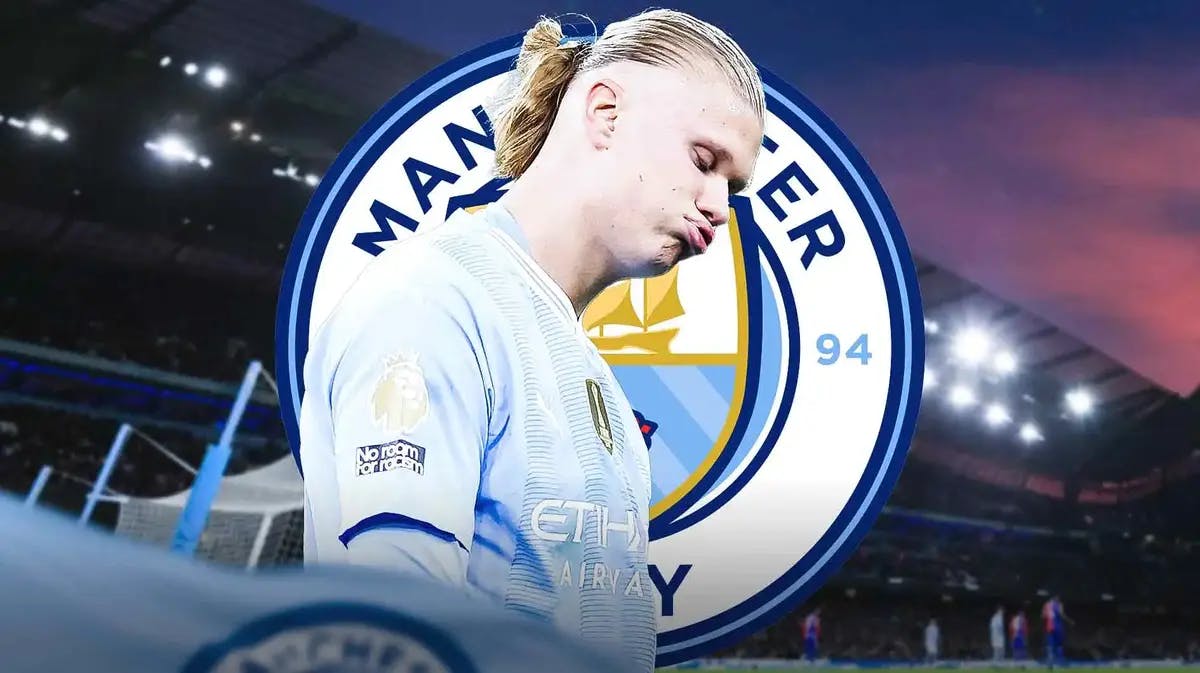 Erling Haaland looking down/sad in the soccer field, the Manchester City logo behind him