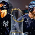 Yankees' Juan Soto on left, Yankees' Aaron Judge on right. MLB World Series Trophy in middle. Yankee Stadium background.