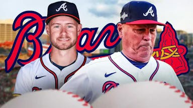 Jarred Kelenic and Brian Snitker in front of a Braves logo