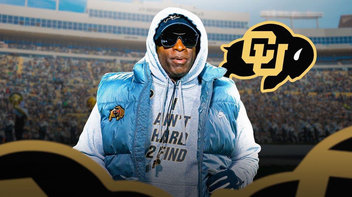 Colorado football coach Deion Sanders look at Buffaloes reporters, Pac-12 fans stand in background