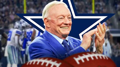 Dallas Cowboys owner Jerry Jones clapping, with players in the background.