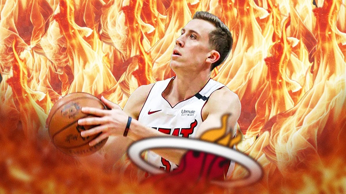 Miami Heat star Duncan Robinson in front of fire while shooting the ball.