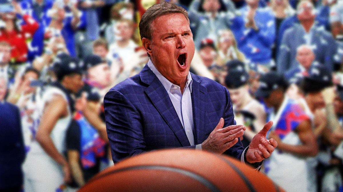Kansas basketball coach Bill Self with players in the background.