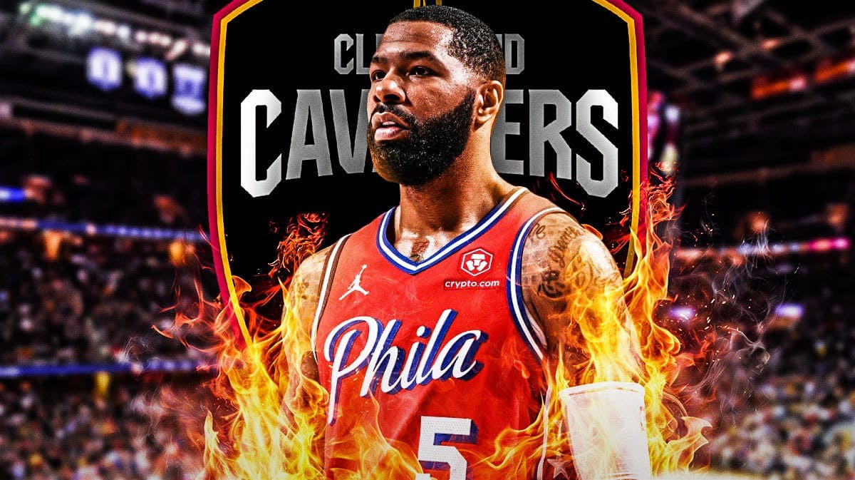 Marcus Morris Sr looking happy with fire around him, Cavs logo, basketball court in background