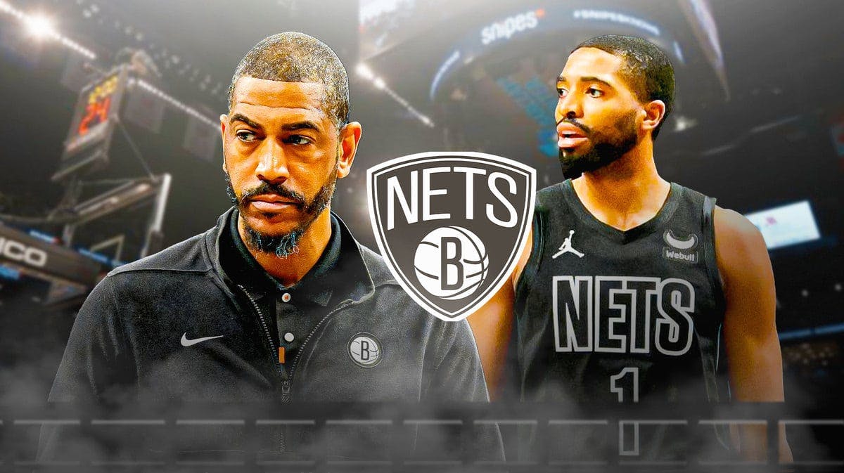 Nets Kevin Ollie and Mikal Bridges next to a Nets logo at Barclays Center