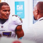 JK Dobbins talking with a doctor