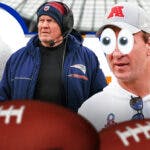 Peyton Manning with eyes in his eyes looking at Bill Belichick and Nick Saban