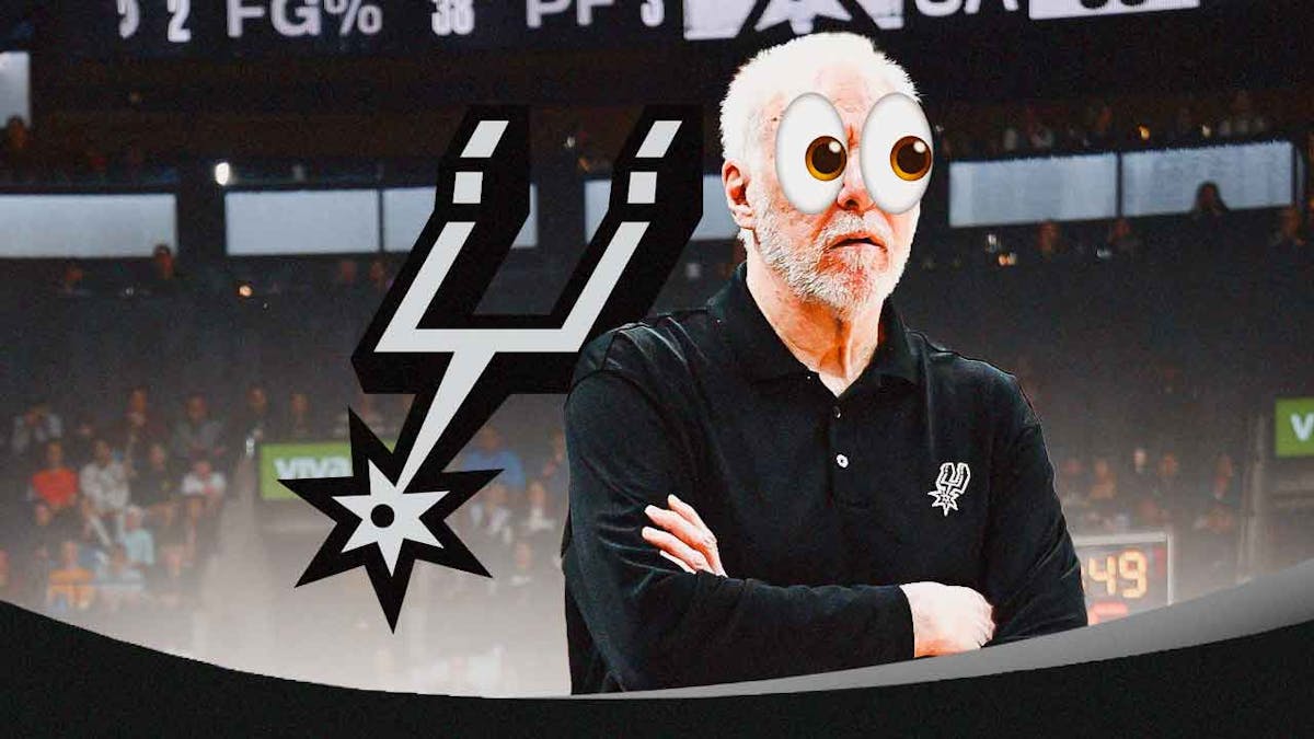 Gregg Popovich next to a Spurs logo at the Frost Bank Center