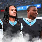 Panthers' 2024 NFL draft picks Jonathon Brooks and Ja'Tavion Sanders in Panthers uniforms.