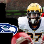 A blank silhouette/outline of a person with the logo for the Seattle Seahawks in the middle. On either side of the silhouette/outline are University of Toledo cornerback Quinyon Mitchell and University of Georgia tackle Amarius Mims.