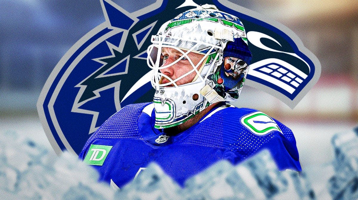 Thatcher Demko (Canucks) looking serious/upset. Canucks' logo in background.