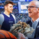 UConn basketball coach Dan Hurley holding lots of money looking at Donovan Clingan.