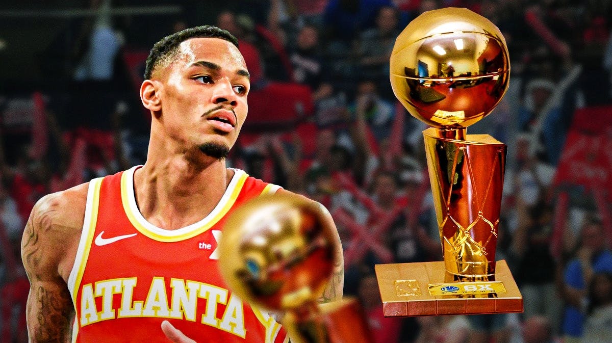 Hawks' Dejounte Murray looking at the Larry O'Brien trophy