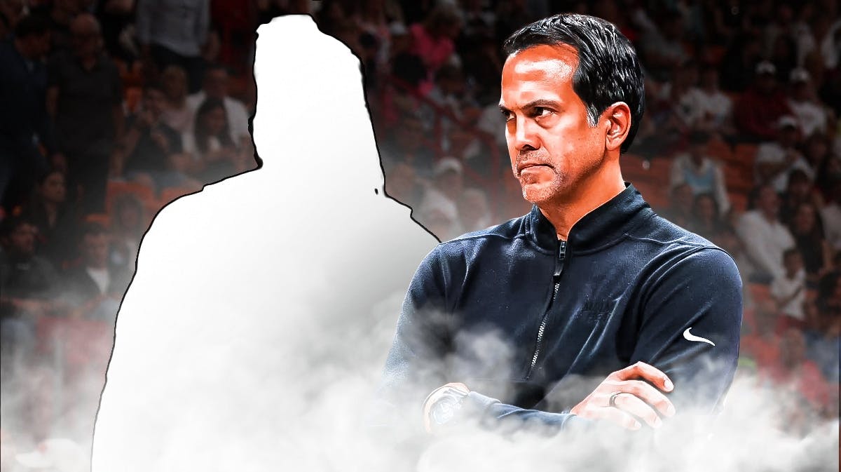 Miami Heat head coach Erik Spoelstra looking at a silhouette of Delon Wright in front of the Kaseya Center.