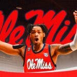 Dre Davis in an Ole Miss Rebels jersey with the Ole Miss logo in the background