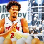 Pistons' Cade Cunningham smiling, with the NBA Draft lottery machine beside him and some ping pong balls scattered all over him