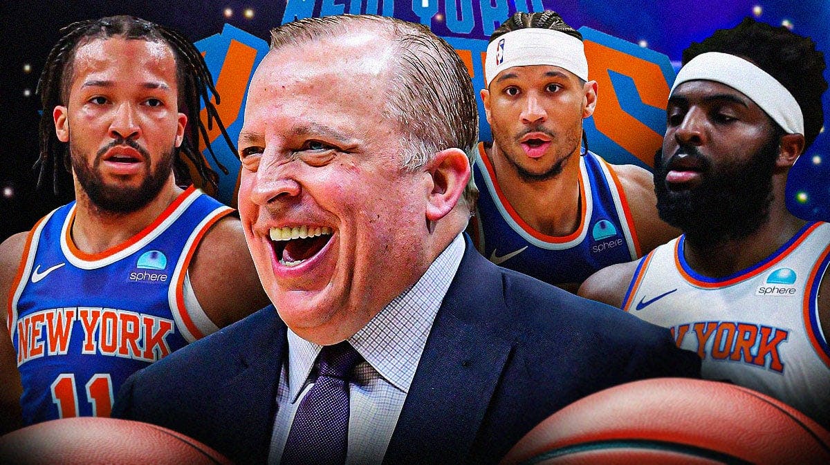 Knicks’ Coach Tom Thibodeau laughing in front of a Knicks logo with Jalen Brunson Josh Hart and Mitchell Robinson around him