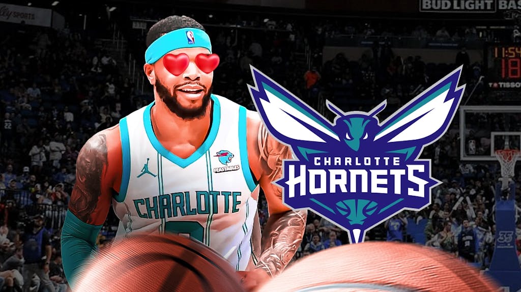 Miles Bridges with heart emoji eyes looking at the Charlotte Hornets logo
