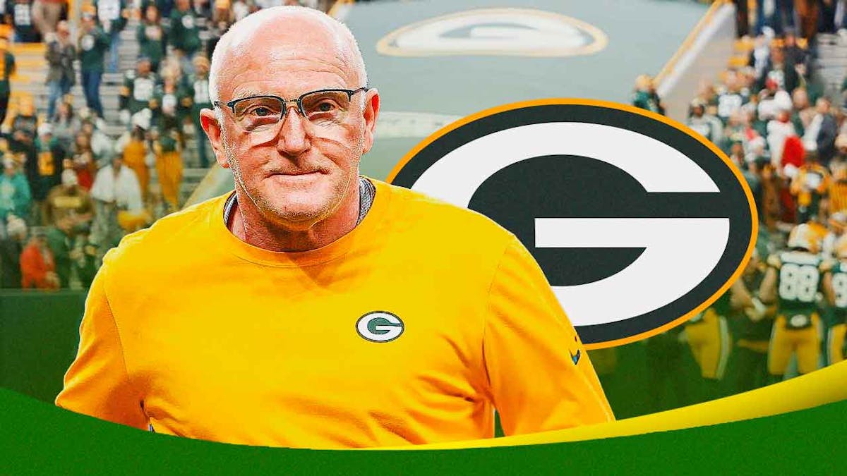 Gordon Batty smiling, Green Bay Packers logo in the background.