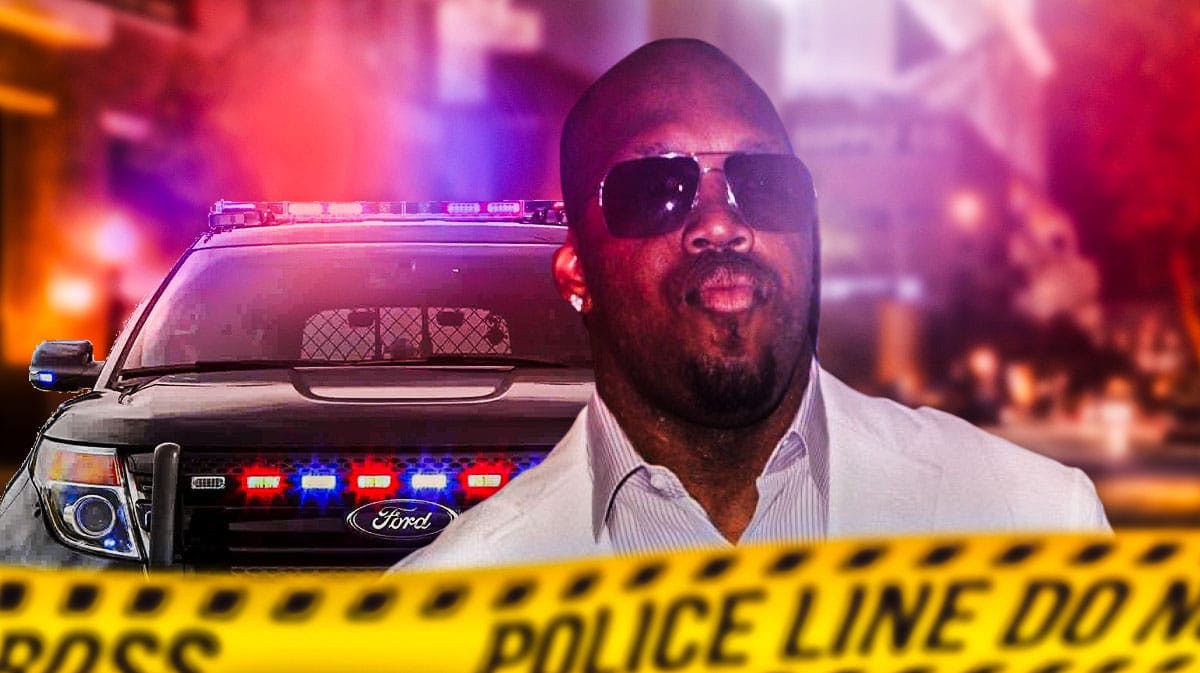 Former Ravens player Terrell Suggs (recent pic, street clothes) with a police car in the backrgound