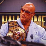 The attached picture of The Rock with his new championship belt with the WWE Hall of Fame logo as the background.