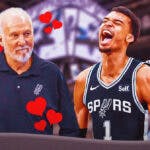Spurs' Gregg Popovich with hearts all over him while smiling at Victor Wembanyama and Devonte' Graham