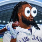 Photo: Vladimir Guerrero Jr looking disappointed in Blue Jays jersey, have peeping eyes around him and Rogers Centre as background.