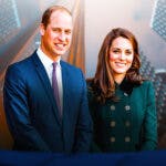 Prince William and Princess Kate with buildings behind them