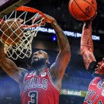 Bulls' Torrey Craig, Bulls' Andre Drummond both dunking a basketball on the same basket.