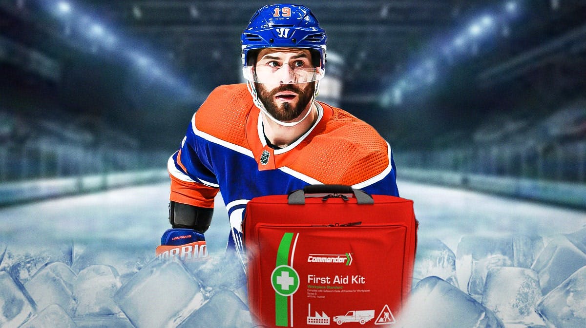 Adam Henrique in an Oilers uniform with a first aid kit