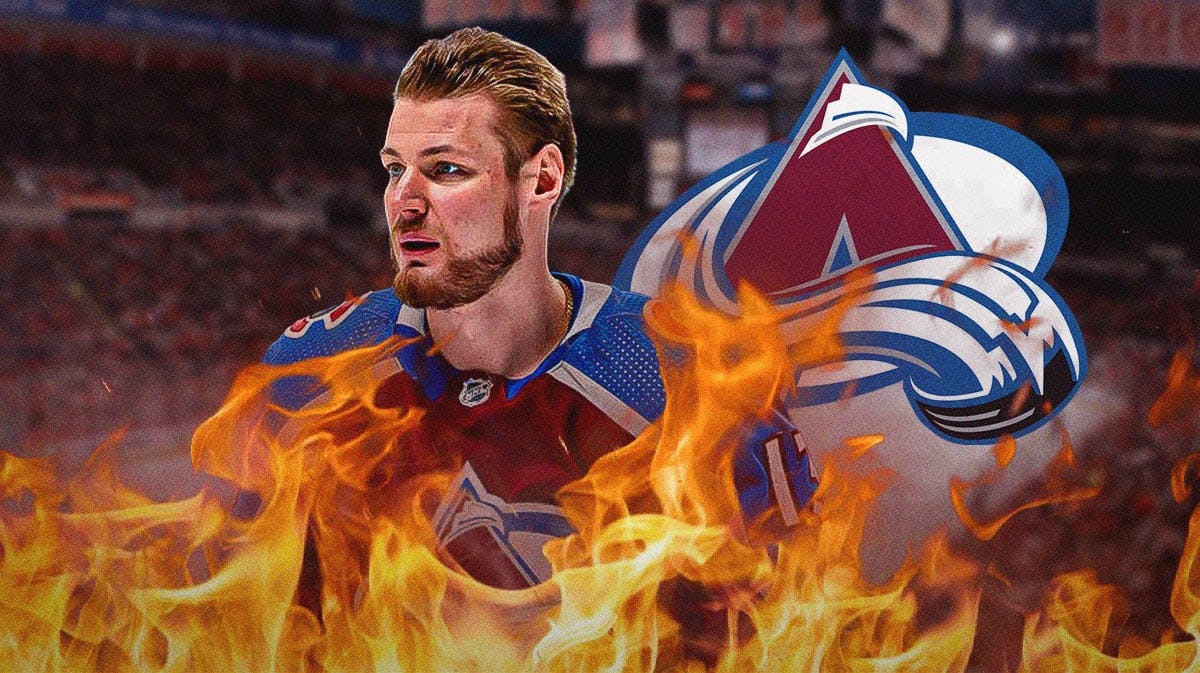 Valeri Nichushkin in middle of image looking happy with fire around him, Colorado Avalanche logo, hockey rink in background